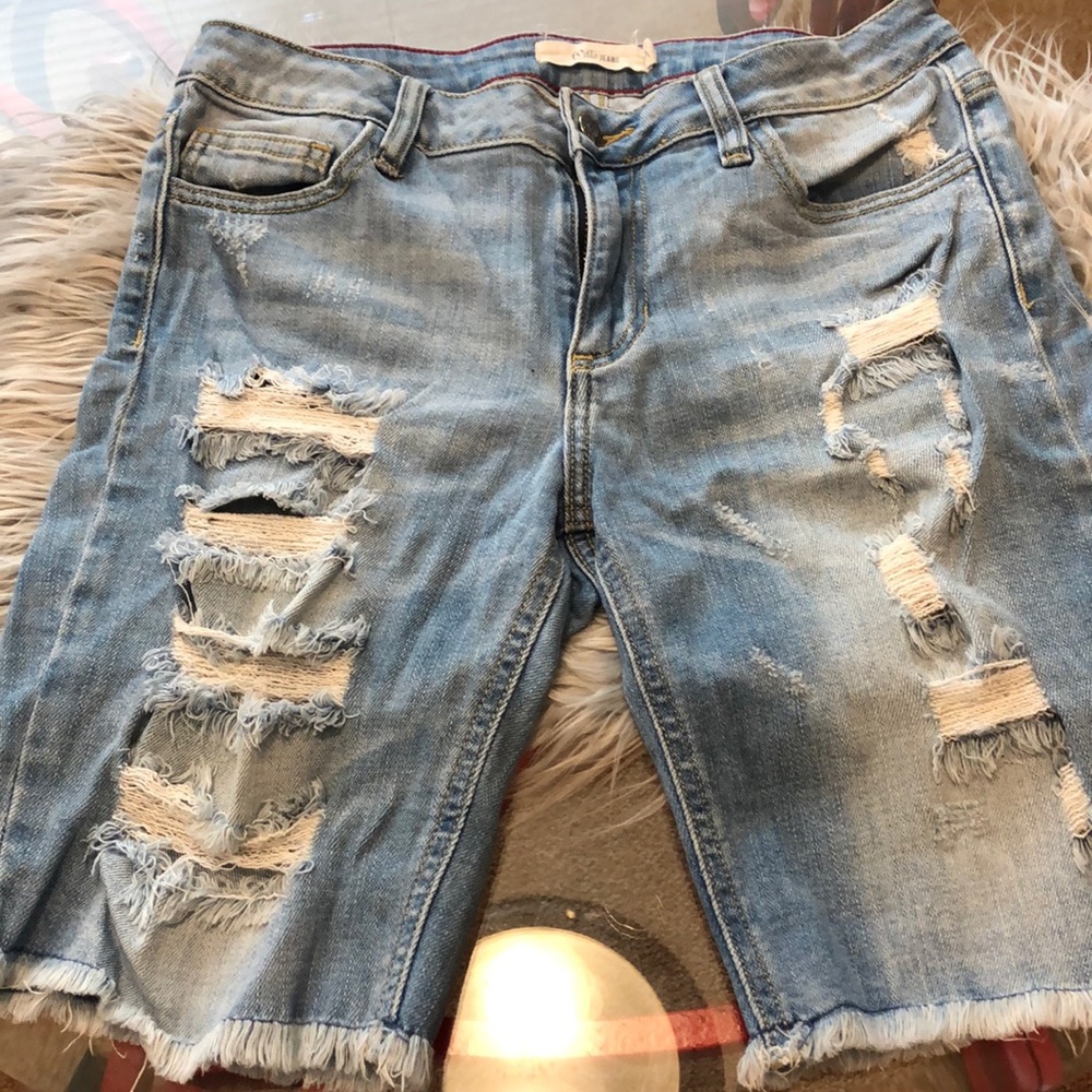 Ripped distressed knee length jeans. Light blue